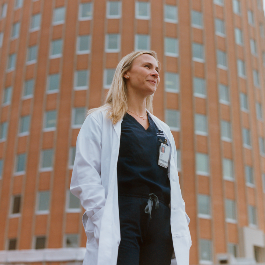Dr. Caroline Scott, orthopaedic surgeon, standing in front of SHN General Hospital.